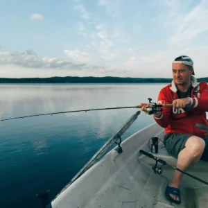 Guest seated on a boat working a rod