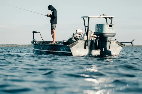Angler fishing from a small boat on the open ocean