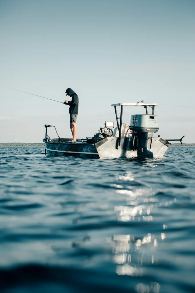 Angler fishing from a small boat on the open ocean