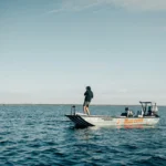 Angler standing aboard a boat in open ocean