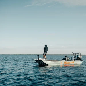 Angler standing aboard a boat in open ocean