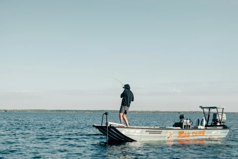 Angler standing aboard a boat in open ocean