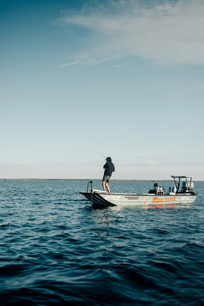 Angler standing aboard a boat in open ocean
