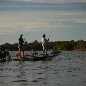 Two anglers working the deck of a boat offshore