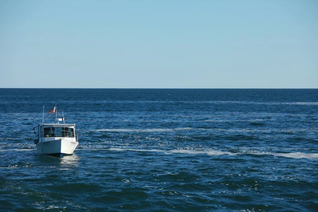 White motorboat at rest on calm water